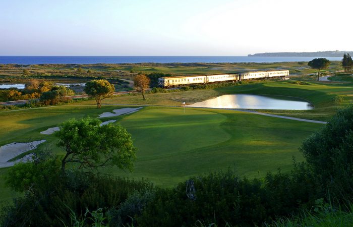 Palmares Golf Course with a train behind passing by